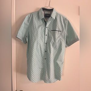 Teal green button up shirt with blue pineapple trees